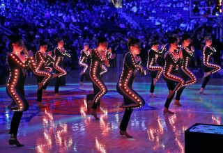 Customized Costumes Feature LED Lights Animating Dancers in Stadium Shows 