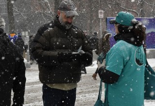 Drug-Free World volunteers distribute booklets in Minnesota during Super Bowl 2018