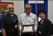 Henry Unger, President of Hitech Systems, Inc., receiving appreciation plaque for Hitech's Diamond Plus sponsorship