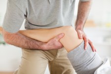 Physical Therapist Holding Patient's Leg