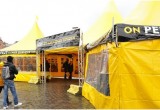 With its signs in French and Dutch to accommodate the bilingual Belgian population, the Scientology Volunteer Ministers European Cavalcade set up their bright yellow pavilion in a square in Antwerp.