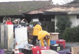 Volunteer Ministers in bright yellow jackets assisting the Stickles family sort through their remaining possessions.