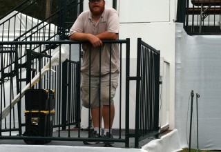 Michael Sok stands proudly in front of one of 101 Mobility's wheelchair lifts for the Web.com Tournament.