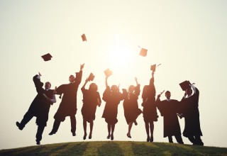 Graduating College Students Throwing Caps