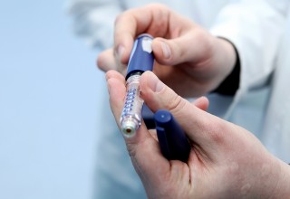 Doctor Showing Insulin