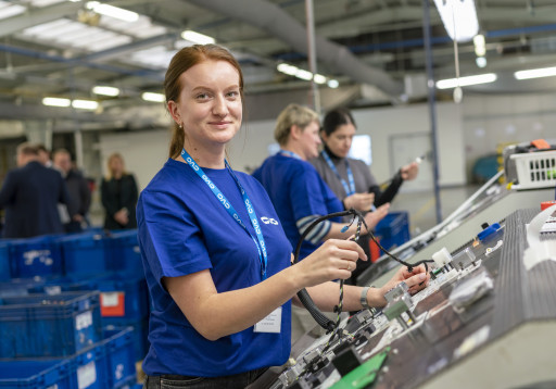 Ukrainian woman in CVG shirts assemblies electrical components in Czech Republic facility