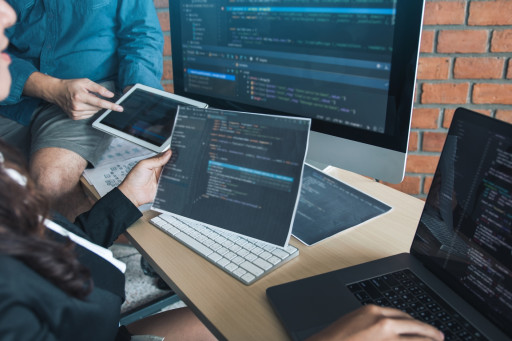 Web engineers working on program codes on computers