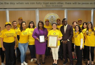 Florida State Senator Daphne Campbell and the Volunteer Ministers of the Church of Scientology Miami, where the senator (center) presented the VMs with a proclamation in recognition of their help.