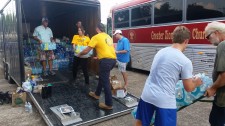 Scientology Volunteer Ministers distribute water to hurricane victims.