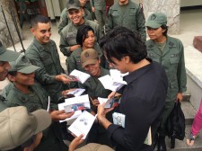 Eduardo Galán autographs copies of The Way to Happiness at National Guard workshop