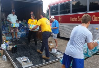 Scientology Volunteer Ministers distribute water to hurricane victims.