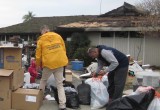 Volunteer Ministers in bright yellow jackets assisting the Stickles family sort through their remaining possessions.