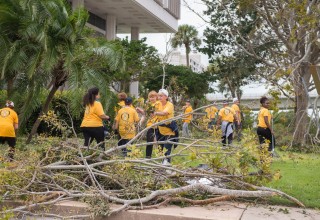 Scientology VMs clear away tree branches and debris in front of Clearwater City Hall, in the wake of Hurricane Irma.