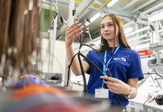 Ukrainian woman assembling electrical components in manufacturing facility