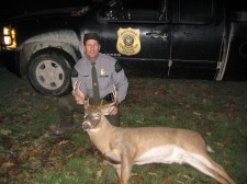 Officer Borkovich with poached 8 point buck