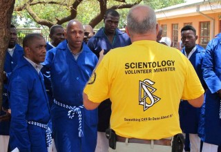 The leader of the African Continental Cavalcade (in yellow)  was guest speaker at this church's Sunday Service. Here  is answering questions from some of the men who attended  his presentation.
