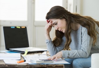 Stressed Woman Looking at Finances
