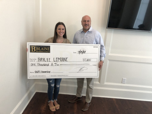 Blaine Barrilleaux Scholarship recipient Baylee Lemoine receives her check from Blaine