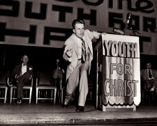 Billy Graham preaches at a Youth For Christ rally. 