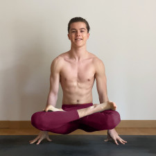 Jules thine a.k.a. julesyogi in scale pose or lifted lotus pose