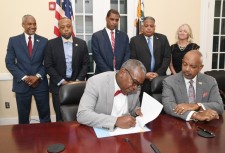 Hon. Albert Bryan, Jr., Governor of the U.S. Virgin Islands, signs the expanded Hotel Development Bill for the USVI