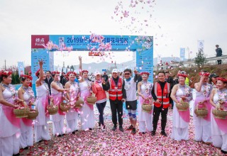 Jin Feibao (center in hat and safety vest) helps open the festivities at the 2019 Beautiful Pear Marathon in An'ning, China